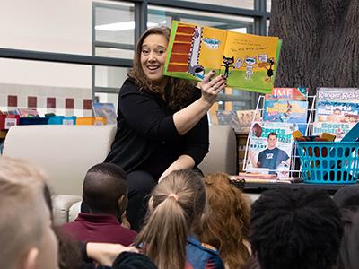 Superintendent Sanford reading Dr. Seuss book to students 