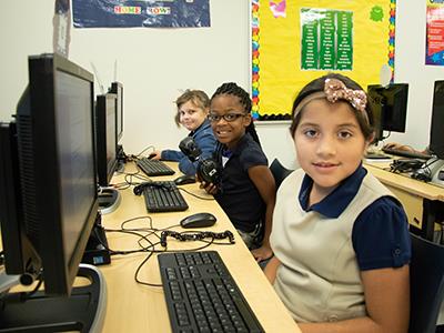 elementary students working on computers 
