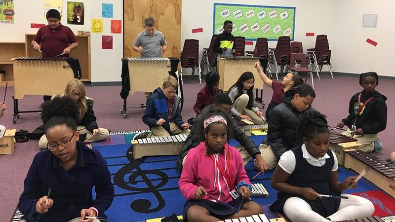 Schupmann students playing musical instruments  