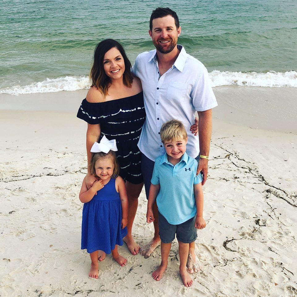 family of mother, father, and two children by the coast family of mother, father, and two children by the coast