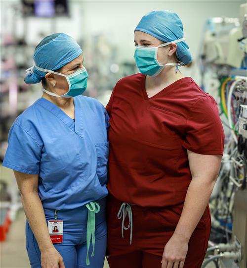  Two doctors with masks looking at each other